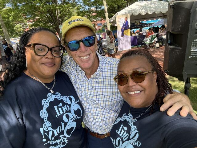 Mike Ramone smiling for a selfie with two women at the August Quarterly Festival in Wilmington.